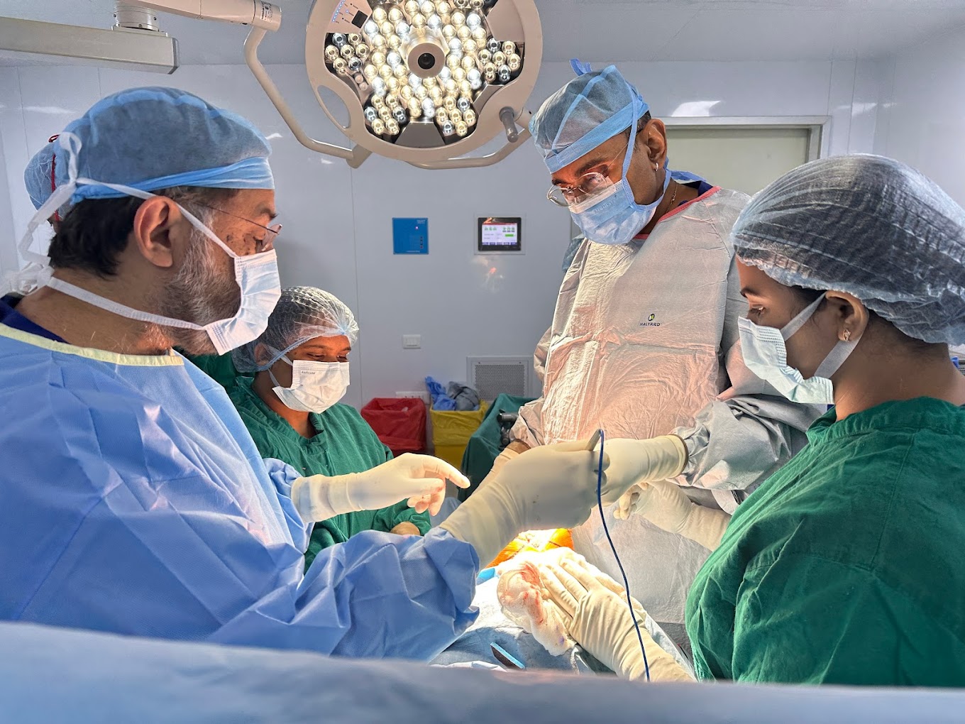Dr. Shahrookh Vatchha using equipment during a surgery