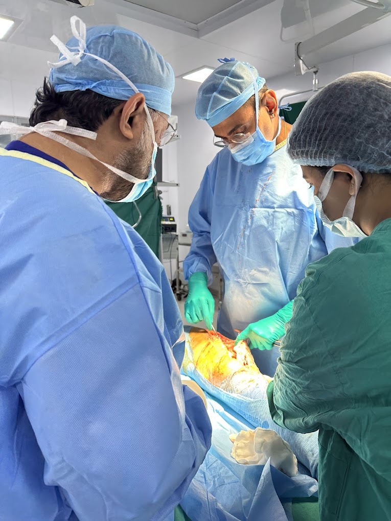 Dr. Shahrookh Vatchha using equipment during an orthopedic surgery